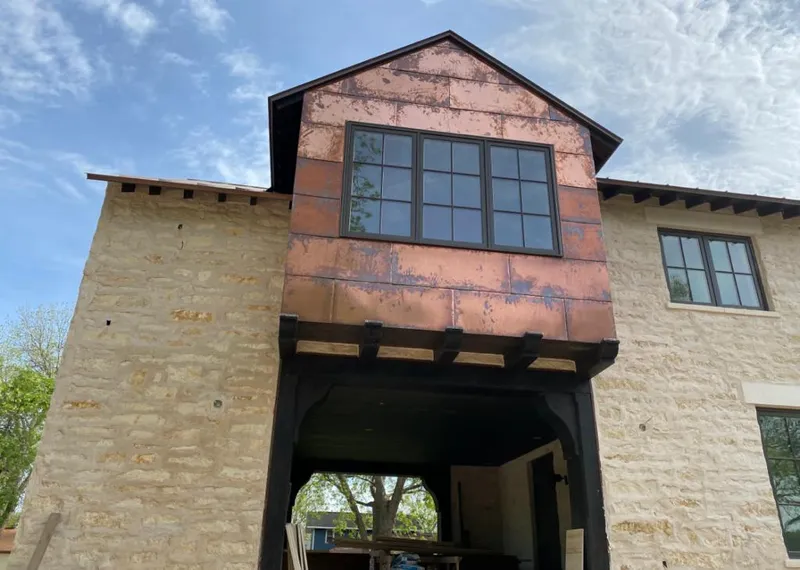 Copper metal panel facade on a stone building for Metal Roof Coating in Sweetwater
